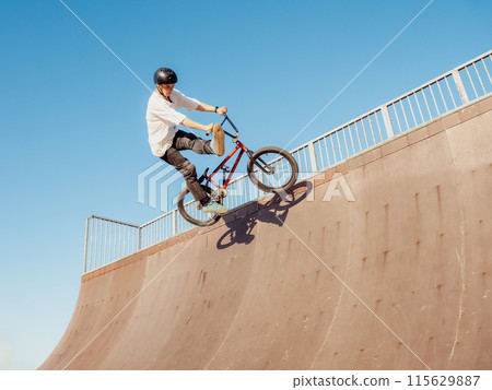 BMX bicycle rider doing trick One Foot Can-Can BMX bicycle rider doing trick One Foot Can-Can 115629887