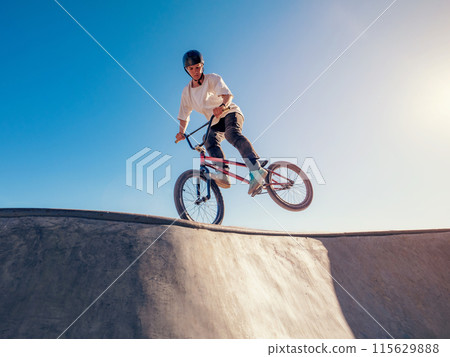 BMX bicycle rider performing Footjam trick BMX bicycle rider performing Footjam trick 115629888