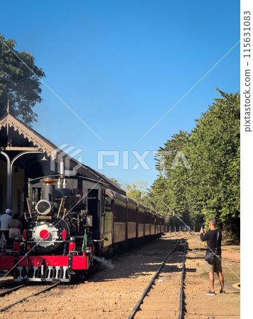 Man Capturing the Essence of Vintage Train Journey Man Capturing the Essence of Vintage Train Journey 115631083
