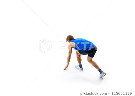 Ready, steady, go. Athletic man, runner standing on starting line, ready for running isolated on white studio background 115631139