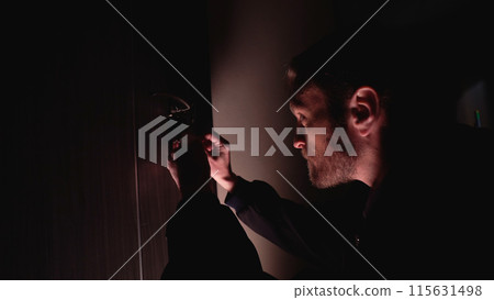 Dangerous criminal attempts to enter a private flat by unlocking the door with a picklock Dangerous criminal attempts to enter a private flat by unlocking the door with a picklock 115631498