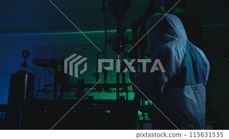In an act of industrial espionage, a man in protective uniform steals secret data in a lab In an act of industrial espionage, a man in protective uniform steals secret data in a lab 115631535