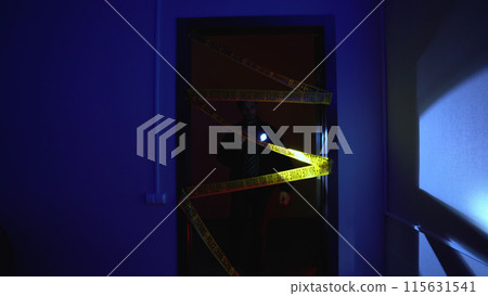 Policeman investigates a crime, examining a murder scene with a flashlight Policeman investigates a crime, examining a murder scene with a flashlight 115631541