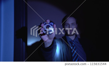 Investigator displays a police badge at the camera, emphasizing crime prevention and law enforcement Investigator displays a police badge at the camera, emphasizing crime prevention and law enforcement 115631544