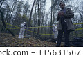 Forensic experts collecting evidence, police investigator writing down case details 115631567