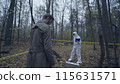 Professional investigators examining a crime scene outdoors, collecting evidence 115631571