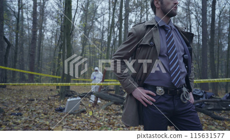Attentive forensic experts collecting evidence at a murder scene, crime investigation Attentive forensic experts collecting evidence at a murder scene, crime investigation 115631577