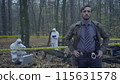 Concerned police detective looking at the camera, experts working at a crime scene 115631578