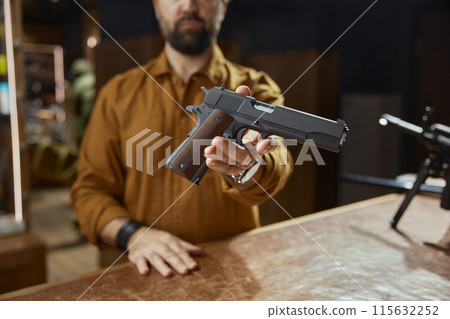 Modern automatic handgun selling at stocks of weapons 115632252