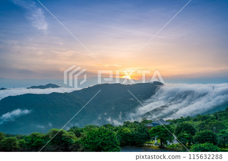 At dawn, the peaceful waterfall of clouds gradually disperses during sunrise. 115632288