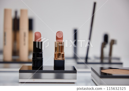 Two matte lipsticks on blurred background 115632325