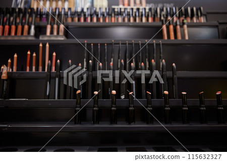 Lip pencils, lipsticks in cosmetics shop 115632327