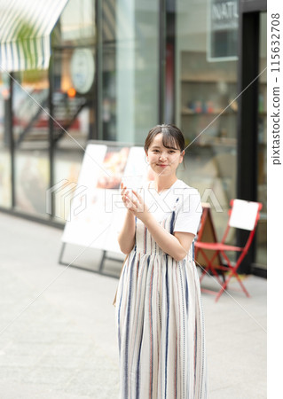 Young and cute Japanese woman drinking water outdoors | Heat stroke prevention | Hydration 115632708