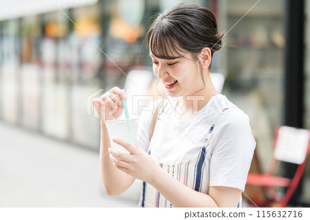 Young and cute Japanese woman drinking water outdoors | Heat stroke prevention | Hydration Young and cute Japanese woman drinking water outdoors | Heat stroke prevention | Hydration 115632716