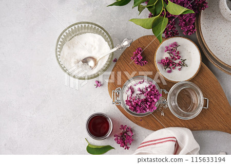 Preparation of syrup from the flowers of lilac. White table and wooden board . Copy space, top view Preparation of syrup from the flowers of lilac. White table and wooden board . Copy space, top view 115633194