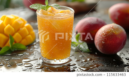 A glass of mango juice with fresh peaches and mint leaves on the table, fresh fruit background, closeup of fruit in focus, glass full of mango drink with ice cubes, tropical summer atmosphere, high re 115633463