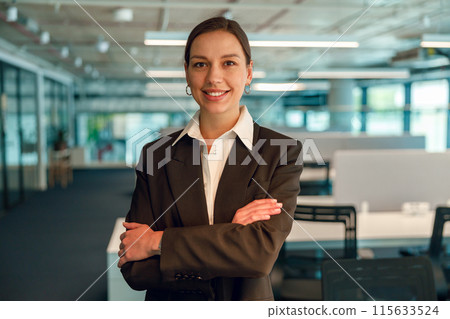Confident businesswoman showing professionalism and successful leadership in corporate environment 115633524