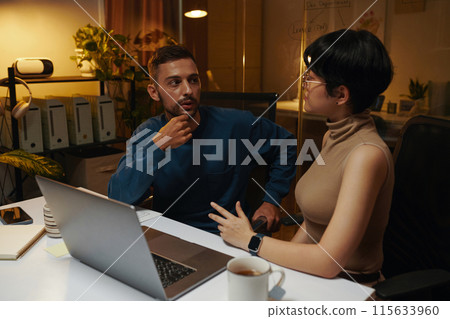 Coworkers Staying Late at Night Coworkers Staying Late at Night 115633960