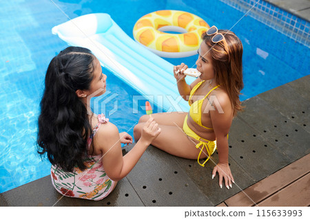 Mother and Daughter Popsicles after Swimming 115633993