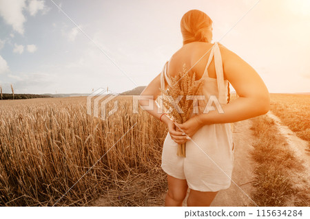 Woman wheat field. Agronomist, Woman farmer check golden ripe barley spikes in cultivated field. Closeup of female hand on plantation in agricultural crop management concept. Slow motion Woman wheat field. Agronomist, Woman farmer check golden ripe barley spikes in cultivated field. Closeup of female hand on plantation in agricultural crop management concept. Slow motion 115634284