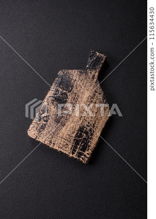 Empty wooden cutting board on dark textured concrete background 115634430