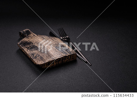 Empty wooden cutting board on dark textured concrete background 115634433