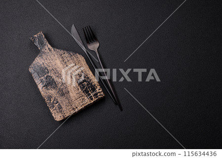 Empty wooden cutting board on dark textured concrete background 115634436