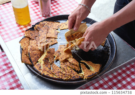 Socca, just coming out of the oven, in Nice, the French Riviera. a type of thin, Socca is a specialty of southeastern French cuisine. a pancake made from chickpea flour. Socca, just coming out of the oven, in Nice, the French Riviera. a type of thin, Socca is a specialty of southeastern French cuisine. a pancake made from chickpea flour. 115634738