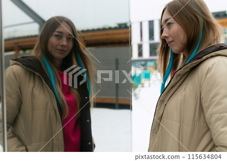 Woman Standing in Front of Mirror 115634804