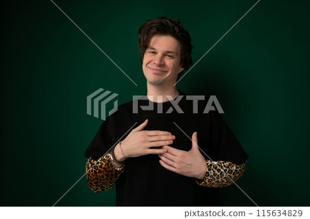 Man Standing in Front of Green Wall 115634829