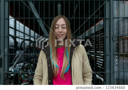 Woman Standing in Front of Metal Gate Woman Standing in Front of Metal Gate 115634888