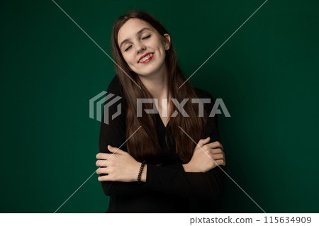 Woman With Arms Crossed in Front of Green Background 115634909