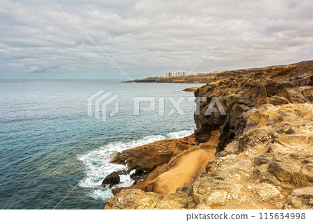 The rocky shore of the island Tenerife in Costa Adeje (Spain) The rocky shore of the island Tenerife in Costa Adeje (Spain) 115634998