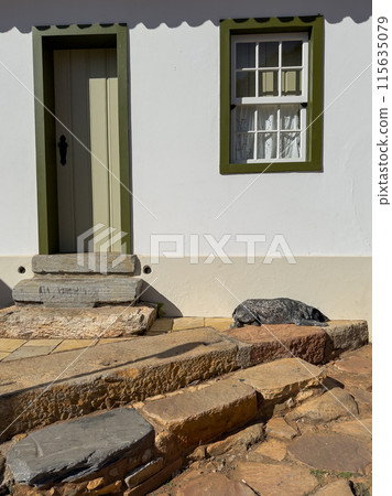 Rustic Doorway With Stone Steps and a Resting Dog 115635079