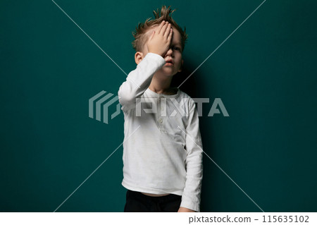 Young Boy Covering His Face With His Hands 115635102