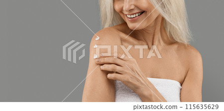 Anti-Aging Skincare. Smiling Mature Woman Applying Body Lotion On Shoulder, Unrecognizable Older Lady Moisturising Skin, Using Nourishing Cream While Standing Isolated On Grey Background, Copy Space Anti-Aging Skincare. Smiling Mature Woman Applying Body Lotion On Shoulder, Unrecognizable Older Lady Moisturising Skin, Using Nourishing Cream While Standing Isolated On Grey Background, Copy Space 115635629