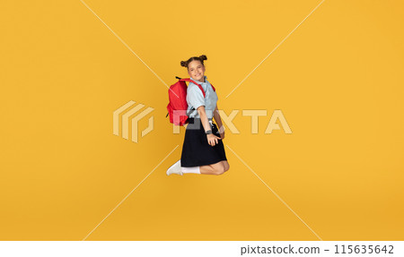Happy caucasian teenager girl pupil with backpack jumping, freeze in air, celebrating victory, have fun, enjoy education, isolated on orange studio background. Study at school, ad and offer, sale 115635642
