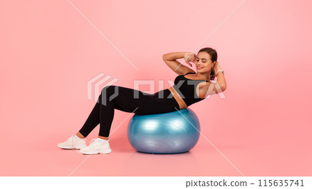 Beautiful Sporty Woman In Activewear Training On Fitness Ball And Smiling, Happy Young Athletic Female Exercising With Swiss Ball Over Pink Studio Background, Panorama With Copy Space 115635741