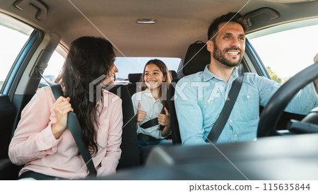 Auto purchase and rent. Happy caucasian family driving new automobile having test drive in city, enjoying road trip, panorama. Parents and child girl spending vacation traveling by car. Auto purchase and rent. Happy caucasian family driving new automobile having test drive in city, enjoying road trip, panorama. Parents and child girl spending vacation traveling by car. 115635844