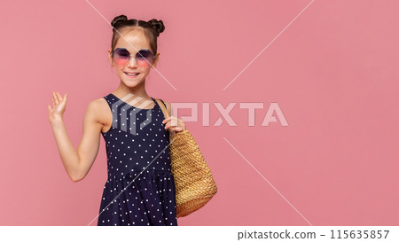 Hello, summer. Adorable stylish girl in sunglasses waving hand, pink studio background 115635857