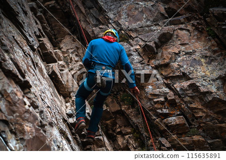 Man is climbing, hiking in the mountains. Man is climbing, hiking in the mountains. 115635891