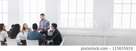 Business meeting of young team. Colleagues discussing successful contract in office, panorama with copy space Business meeting of young team. Colleagues discussing successful contract in office, panorama with copy space 115635919