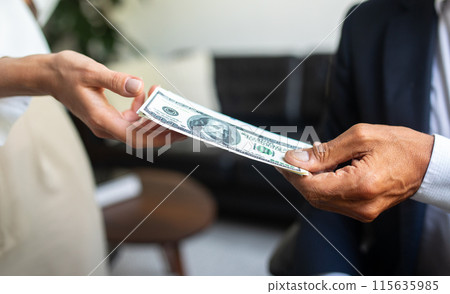Caucasian old businessman in suit gives money dollars cash to woman hand in office interior, close up, cropped. Finance work and modern business, salary and profit, credit Caucasian old businessman in suit gives money dollars cash to woman hand in office interior, close up, cropped. Finance work and modern business, salary and profit, credit 115635985