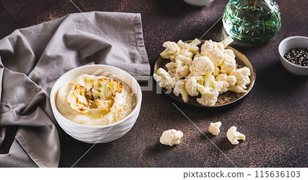 Homemade creamy cauliflower soup in a bowl on the table web banner Homemade creamy cauliflower soup in a bowl on the table web banner 115636103