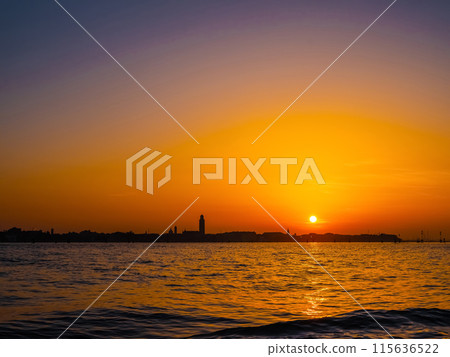 silhouettes of Venice at sunset , view from water 115636522