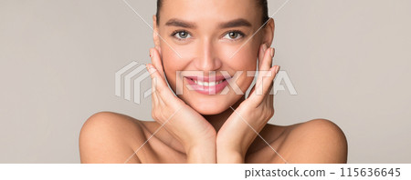 A young woman is standing in front of the camera, posing with both hands covering her face. She appears to be expressing emotion or concealing her face from view. A young woman is standing in front of the camera, posing with both hands covering her face. She appears to be expressing emotion or concealing her face from view. 115636645