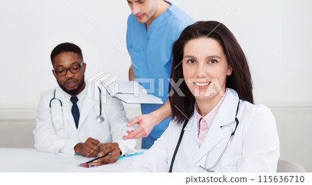 Female Doctor At Conference Holding Medical Report, Looking At Camera 115636710