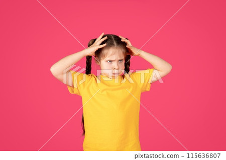 Cheerful Preteen Caucasian Girl Fooling Over Pink Background, Funny Little Female Child In Casual Clothes Grimacing And Touching Head With Hands, Frustrated Kid Looking Aside At Copy Space 115636807