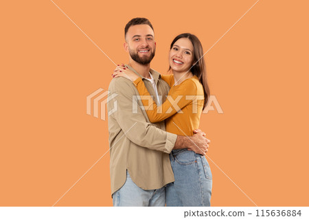 A man and woman are tightly embracing each other, showing affection and closeness in this moment. Their bodies are entwined, demonstrating a strong bond between them. A man and woman are tightly embracing each other, showing affection and closeness in this moment. Their bodies are entwined, demonstrating a strong bond between them. 115636884