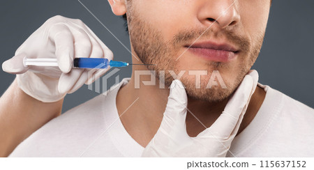 Plastic surgery concept. Young man receiving injection in his face, panorama Plastic surgery concept. Young man receiving injection in his face, panorama 115637152